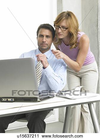Business couple at the computer View Large Photo Image Stock Image - Business couple at the computer. Fotosearch