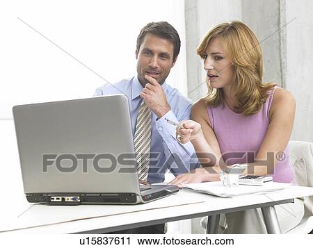 Business couple at the computer View Large Photo Image Stock Image - Business couple at the computer. Fotosearch
