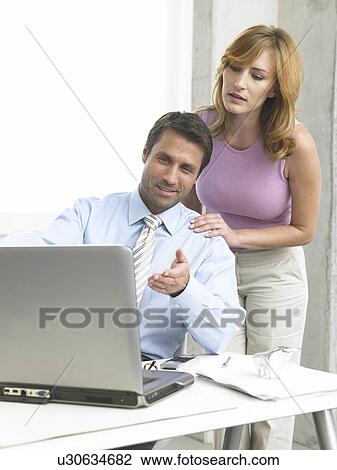 Stock Image - Business couple at the computer. Fotosearch