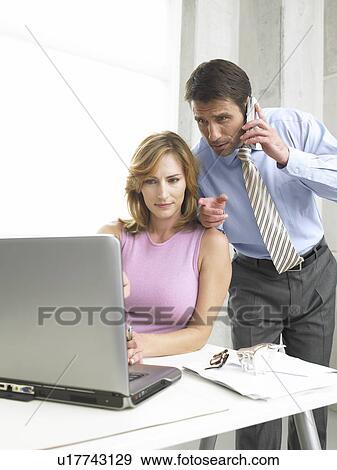 Stock Photo - Business couple at the computer. Fotosearch