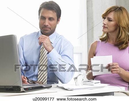Business couple at the computer View Large Photo Image Stock Photo - Business couple at the computer. Fotosearch