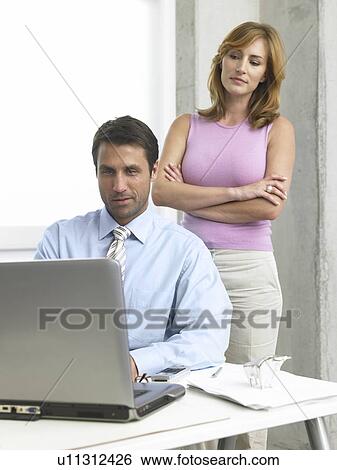 Stock Photograph - Business couple at the computer. Fotosearch