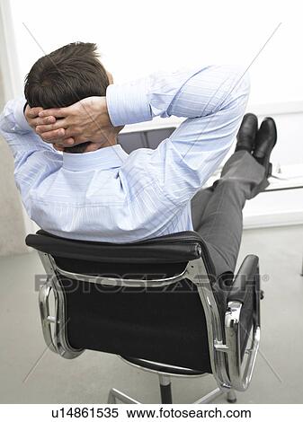 Business man at his desk is relaxing View Large Photo Image Stock Photography - Business man at his desk is relaxing. Fotosearch