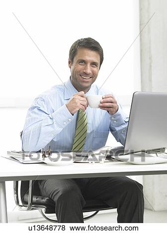 Business man is drinking coffee View Large Photo Image Stock Photo - Business man is drinking coffee. Fotosearch
