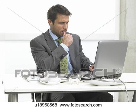 Stock Photo - Business man looking serious. Fotosearch
