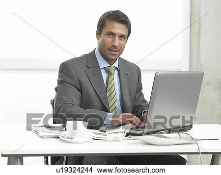Business man working with a notebook View Large Photo Image Picture - Business man working with a notebook. Fotosearch