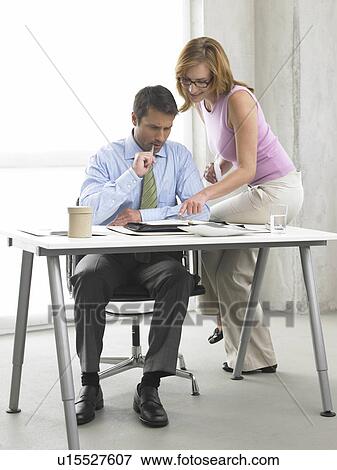 Stock Photo - Business woman and man at the desk. Fotosearch