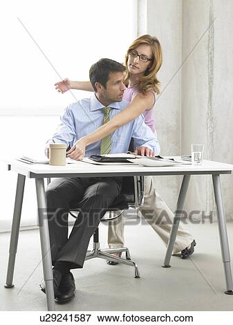 Stock Photo - Business woman and man at the desk. Fotosearch