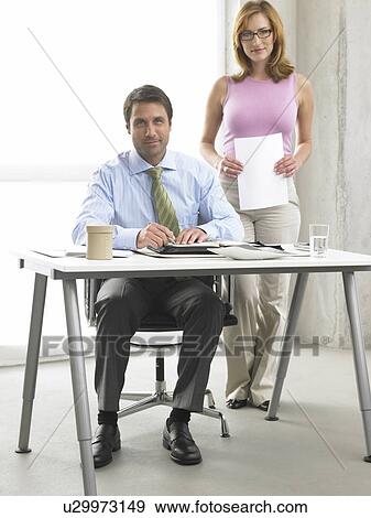Business woman and man at the desk View Large Photo Image Stock Photo - Business woman and man at the desk. Fotosearch