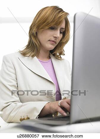 Business woman is working with her notebook View Large Photo Image Stock Photo - Business woman is working with her notebook. Fotosearch