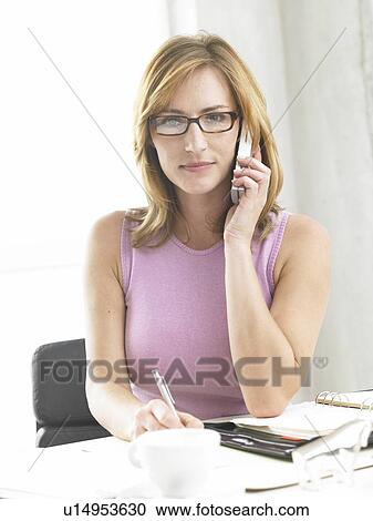 Business woman writing and phoning View Large Photo Image Stock Image - Business woman writing and phoning. Fotosearch