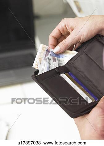 Stock Photo - Cash in a purse. Fotosearch