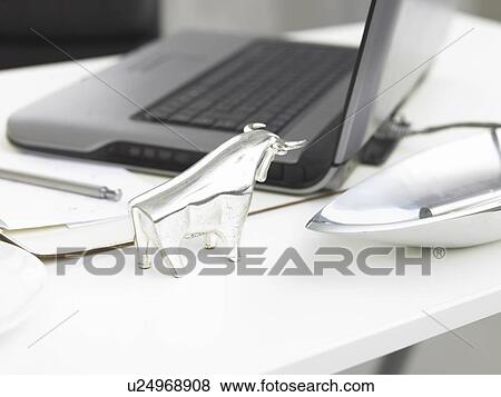Stock Photo - Glass bull on a desk. Fotosearch