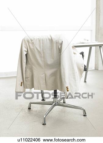Stock Photograph - Jacket hanging on the desk chair. Fotosearch