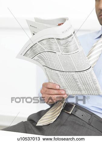 Stock Image - Man is reading the newspaper. Fotosearch