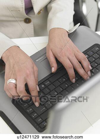 Stock Photo - Typing with a notebook. Fotosearch