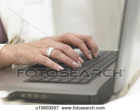 Stock Photo - Typing with a notebook. Fotosearch