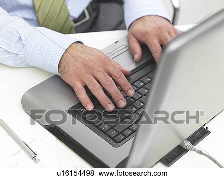 Typing with a notebook View Large Photo Image Stock Photo - Typing with a notebook. Fotosearch