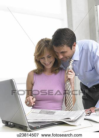 Stock Photo - Woman is pulling his tie. Fotosearch