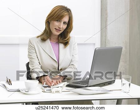 Stock Image - Writting business woman. Fotosearch