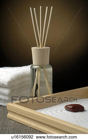 Stock Image - Aroma lamp with aroma sticks, towels and a gemstone. Fotosearch