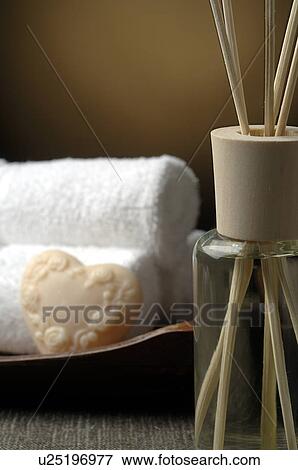 Stock Photo - Aroma lamp with aroma sticks, towels and soap. Fotosearch