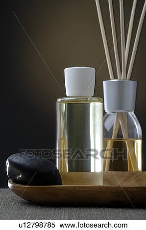 Stock Photography - Aroma sticks, cosmetic bottle and a black stone. Fotosearch