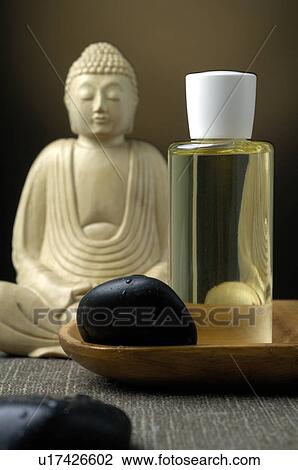 Buddha with a cosmetic bottle and black stones View Large Photo Image Stock Image - Buddha with a cosmetic bottle and black stones. Fotosearch