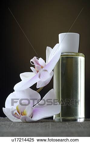 Stock Photography - Cosmetic bottle with orchid blossoms. Fotosearch