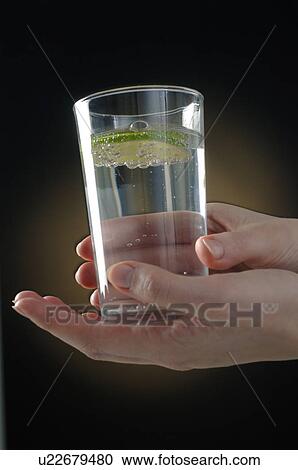Hand is holding a glas of water View Large Photo Image Stock Image - Hand is holding a glas of water. Fotosearch
