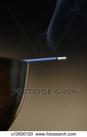 Stock Image - Joss stick on a bowl. Fotosearch