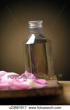 Stock Photo - Oil with pink petals. Fotosearch