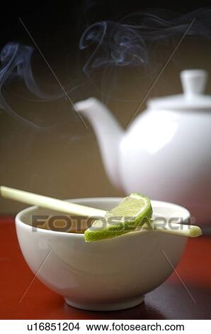 Teapot and a cup of tea with a piece of lime View Large Photo Image Picture - Teapot and a cup of tea with a piece of lime. Fotosearch