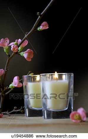 Stock Photograph - Two candles and a cherry twig. Fotosearch