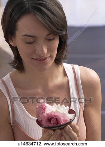 Stock Image - Woman and lily blossoms. Fotosearch