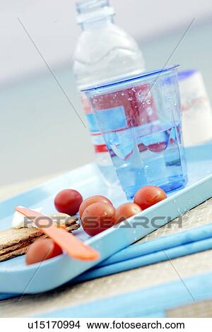 A glass of water, tomatoes and crispbread on a tray View Large Photo Image Picture - A glass of water, tomatoes and crispbread on a tray. Fotosearch