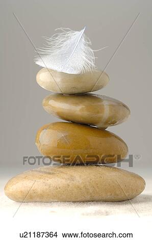 Picture - A stack of stones and a feather. Fotosearch