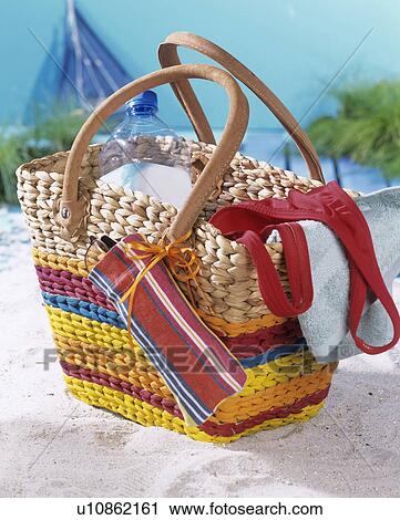 Stock Image - Beach bag with stripes and small mobile phone (or spectacle) case. Fotosearch