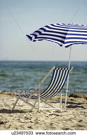 Blue and white sunshade and deckchair on the beach View Large Photo Image Stock Image - Blue and white sunshade and deckchair on the beach. Fotosearch