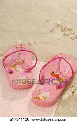 Pink flip flops in the sand View Large Photo Image Stock Photograph - Pink flip flops in the sand. Fotosearch