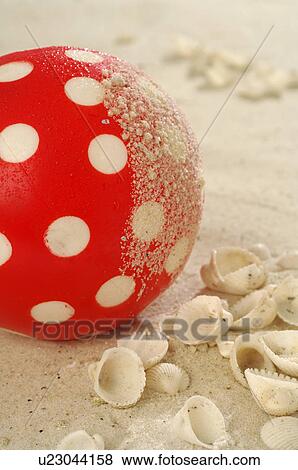 Stock Photo - Plastic ball in the sand. Fotosearch
