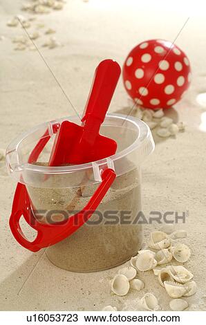 Stock Image - Toy bucket and shovel in the sand. Fotosearch