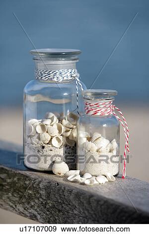 Two pharmacy bottles filled with sand and shells View Large Photo Image Stock Photo - Two pharmacy bottles filled with sand and shells. Fotosearch