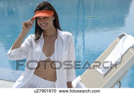 Stock Image - Woman wearing a cap at the swimming pool. Fotosearch
