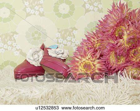 Stock Image - Bouquet of chrysanthemum and a pair of lady`s shoes. Fotosearch