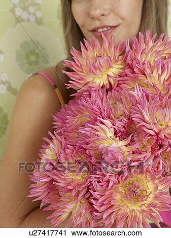Stock Image - Woman with a bouquet of chrysanthemum. Fotosearch