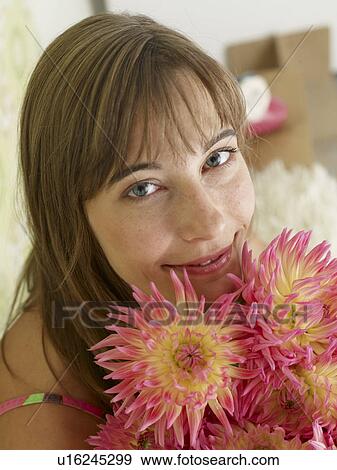 Stock Photo - Woman with a bouquet of chrysanthemum. Fotosearch