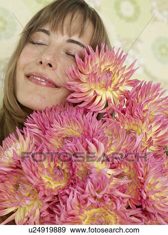 Stock Photo - Woman with a bouquet of chrysanthemum. Fotosearch