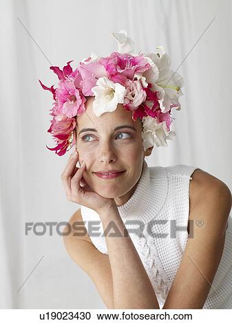 Stock Image - Woman with a flower cap. Fotosearch