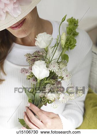 Woman with a hat and a bouquet View Large Photo Image Stock Image - Woman with a hat and a bouquet. Fotosearch